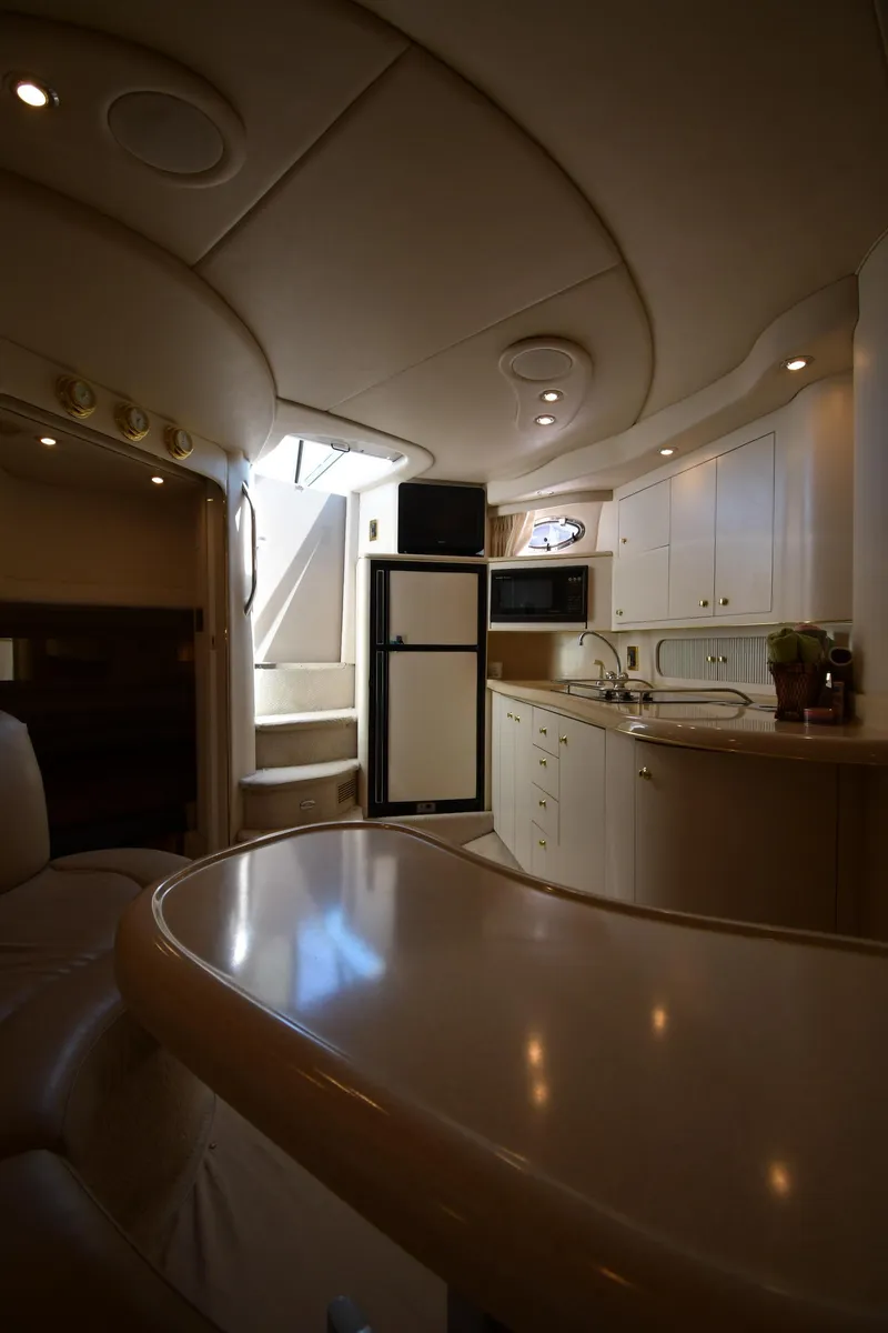 Slide: The Image of Luxurious interior of a 1997 Sea Ray 400 Sundancer yacht, featuring a modern kitchen area. - 43