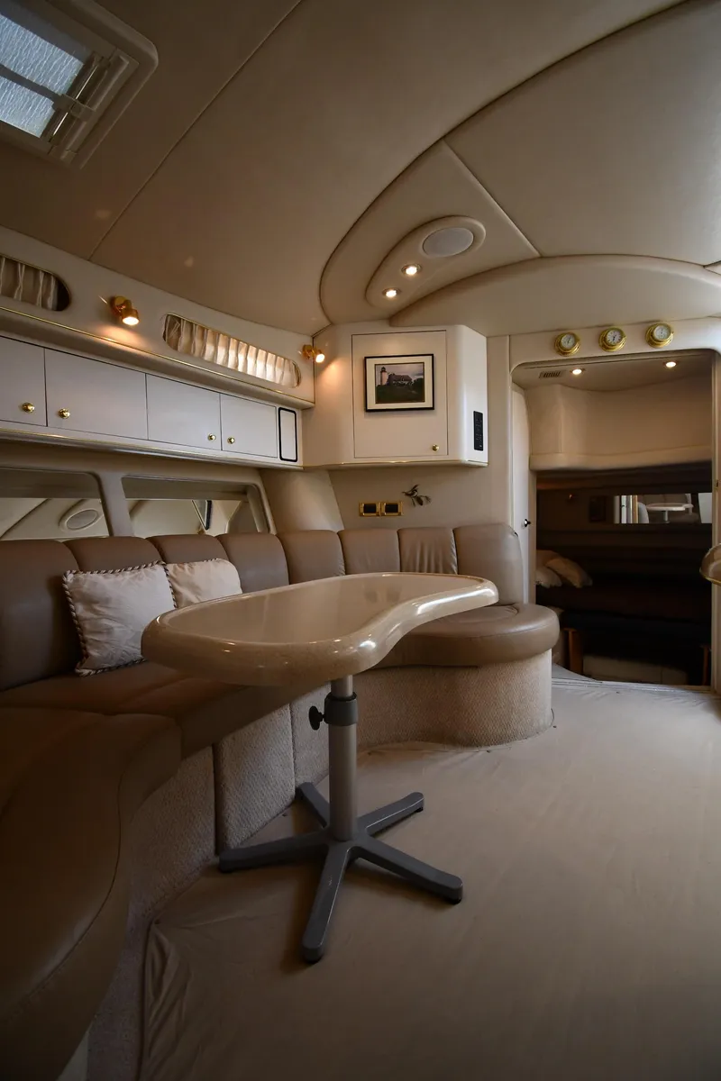 Slide: The Image of Luxurious interior of a 1997 Sea Ray 400 Sundancer yacht with elegant seating and table. - 45