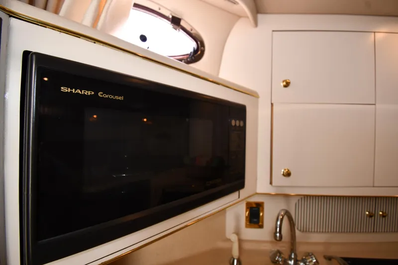 Slide: The Image of Interior of 1997 Sea Ray 400 Sundancer with Sharp Carousel microwave and cabinetry. - 48