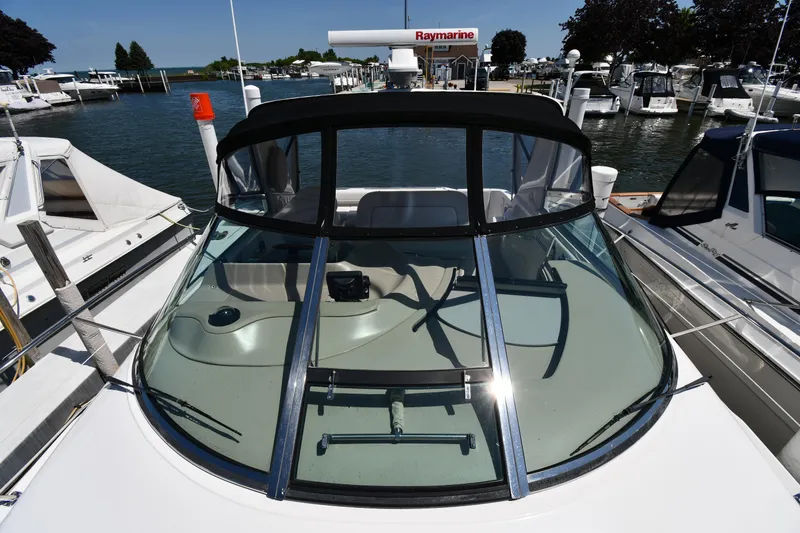 Slide: The Image of 1997 Sea Ray 400 Sundancer yacht docked at marina, featuring sleek design and spacious cockpit. - 6