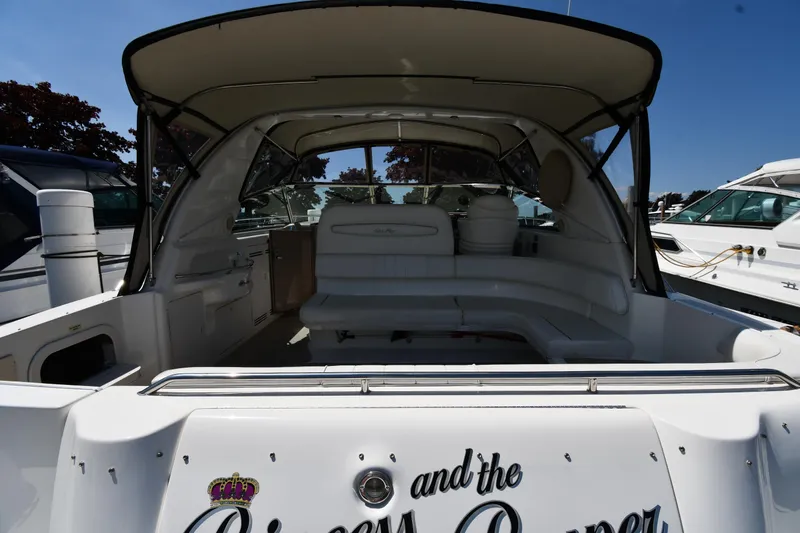 Slide: The Image of 1997 Sea Ray 400 Sundancer yacht interior with seating and canopy, docked at marina. - 7