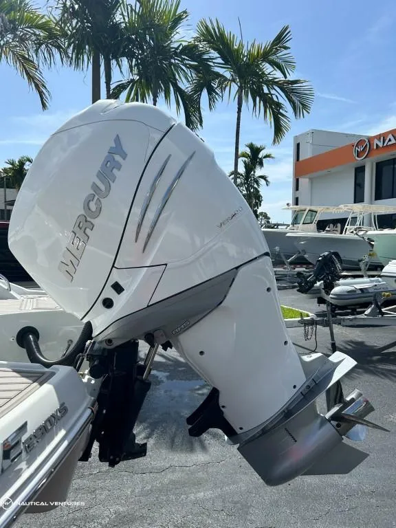 Slide: The Image of 2024 Crownline E290 XS with Mercury outboard motor in a marina. - 14