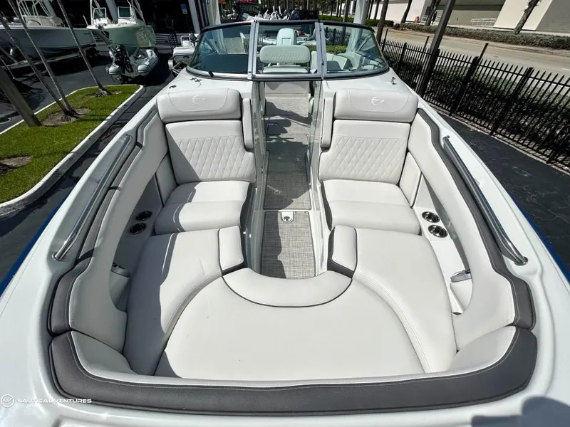 Slide: The Image of 2024 Crownline E290 XS boat with spacious seating and modern design. - 8