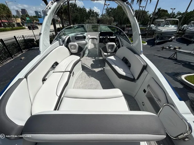Slide: The Image of 2024 Crownline E290 XS boat interior with spacious seating and modern design. - 9
