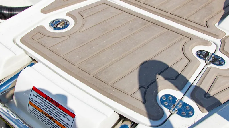 Slide: The Image of 2023 Crownline 290 XSS boat deck with non-slip surface and hardware details. - 21