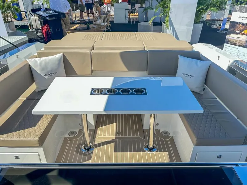 Slide: The Image of Luxurious seating area on the 2024 De Antonio Yachts D36 OPEN with a sleek table and cushions. - 16