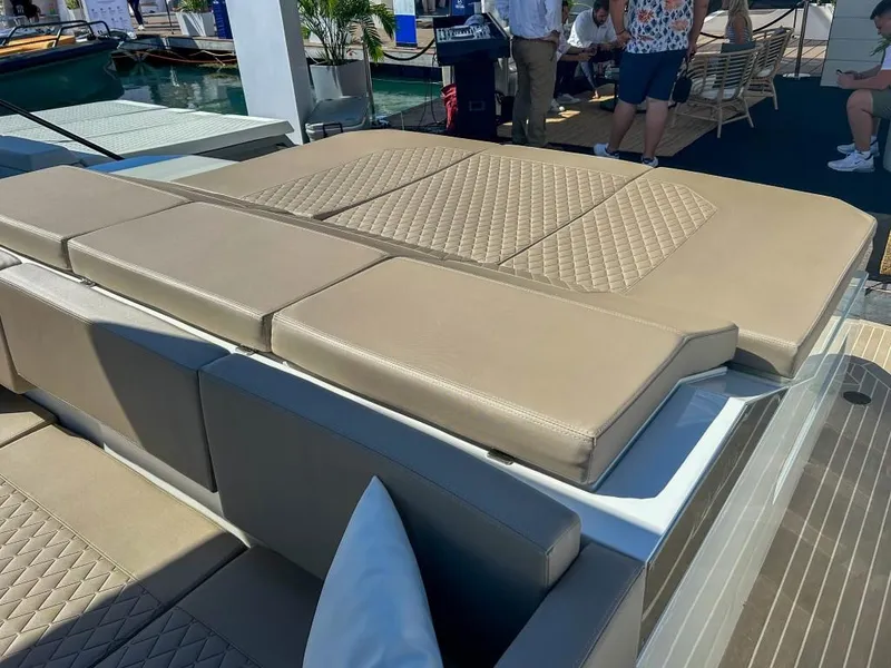 Slide: The Image of 2024 De Antonio Yachts D36 OPEN luxury yacht with beige cushioned seating at a boat show. - 18