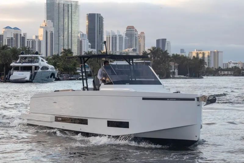 Slide: The Image of 2024 De Antonio Yachts D36 OPEN cruising in a city harbor with skyscrapers in the background. - 3