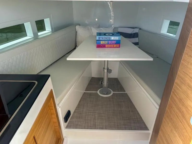 Slide: The Image of Interior of 2024 De Antonio Yachts D28 Cruiser with cozy seating and table. - 13