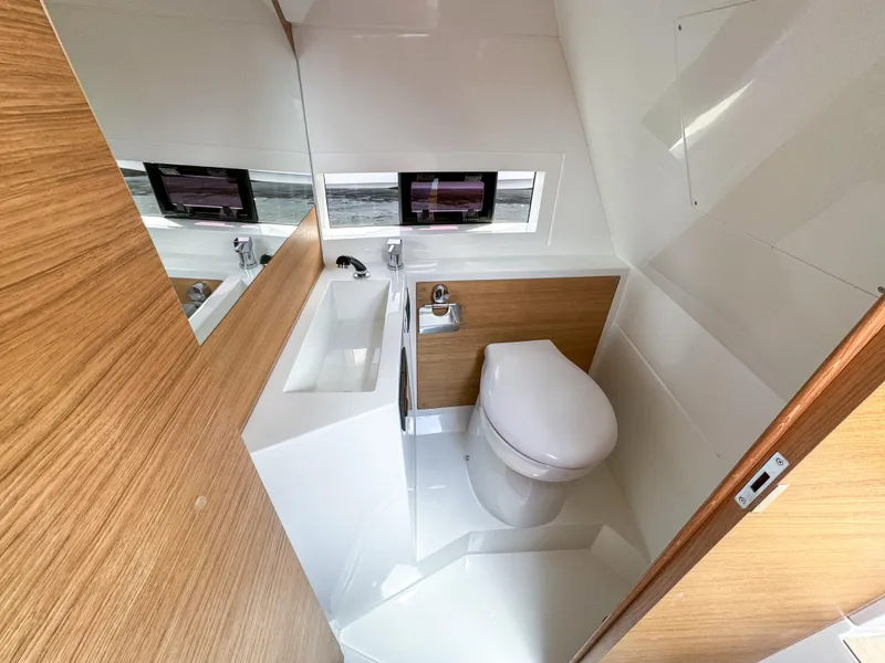 Slide: The Image of Bathroom interior of 2024 De Antonio Yachts D28 Cruiser, featuring modern fixtures and wood accents. - 14