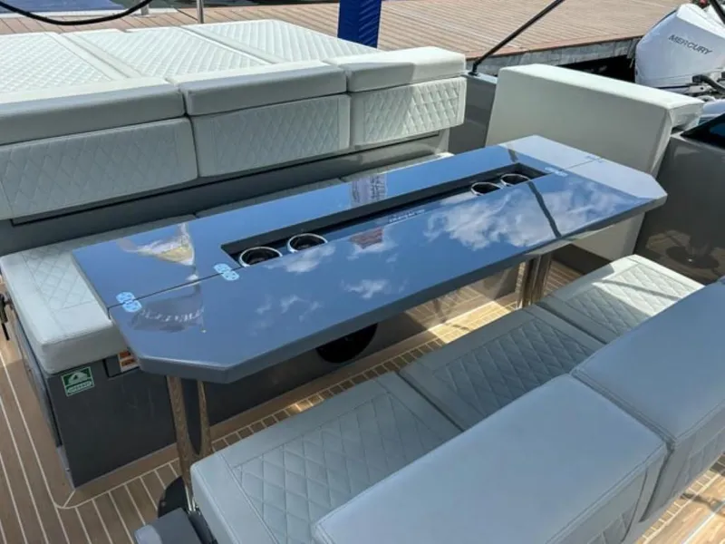 Slide: The Image of 2024 De Antonio Yachts D28 Cruiser interior with sleek seating and modern table design. - 19
