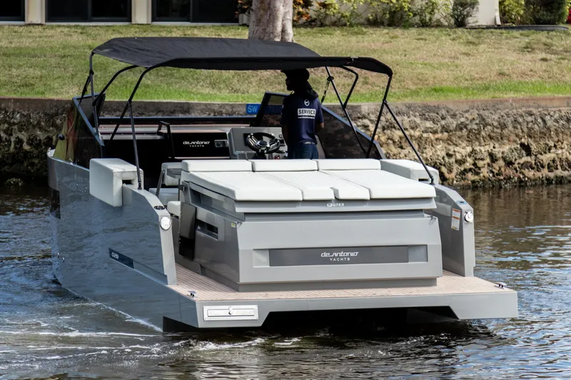 Slide: The Image of 2024 De Antonio Yachts D28 Cruiser on water, featuring sleek design and spacious deck. - 2