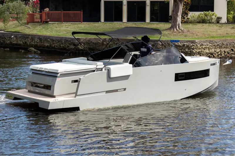 Slide: The Image of 2024 De Antonio Yachts D28 Cruiser on a serene waterway, showcasing sleek design and modern features. - 24