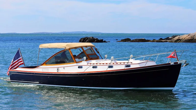 The Image of Classic 1995 Able 44 boat cruising on a calm sea with American flag. - 0