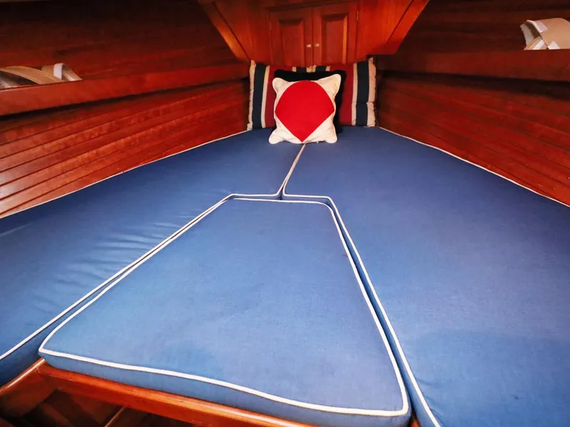 Slide: The Image of Cozy cabin interior with blue cushions and decorative pillows on a 1995 Able 44 boat. - 14