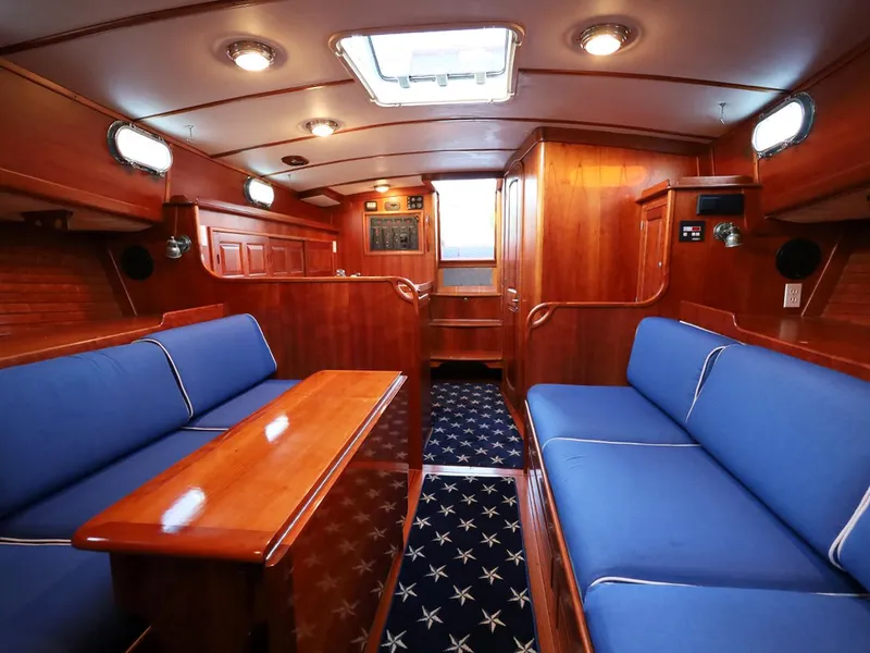 Slide: The Image of Luxurious 1995 Able 44 yacht interior with blue seating and wooden finishes. - 15
