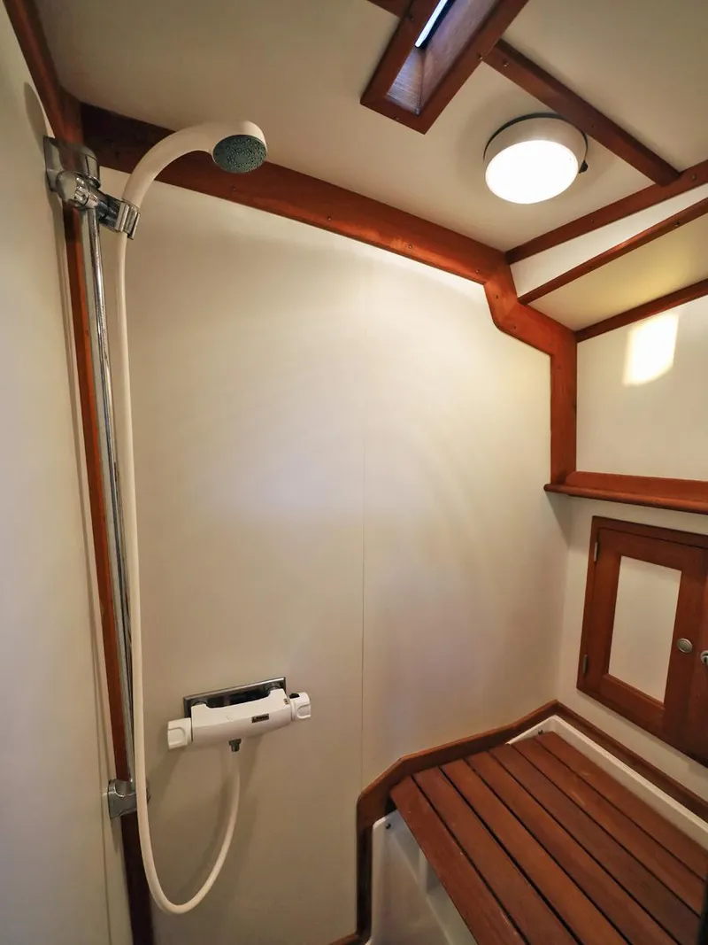 Slide: The Image of 1995 Able 44 yacht shower with wooden accents and modern fixtures. - 17
