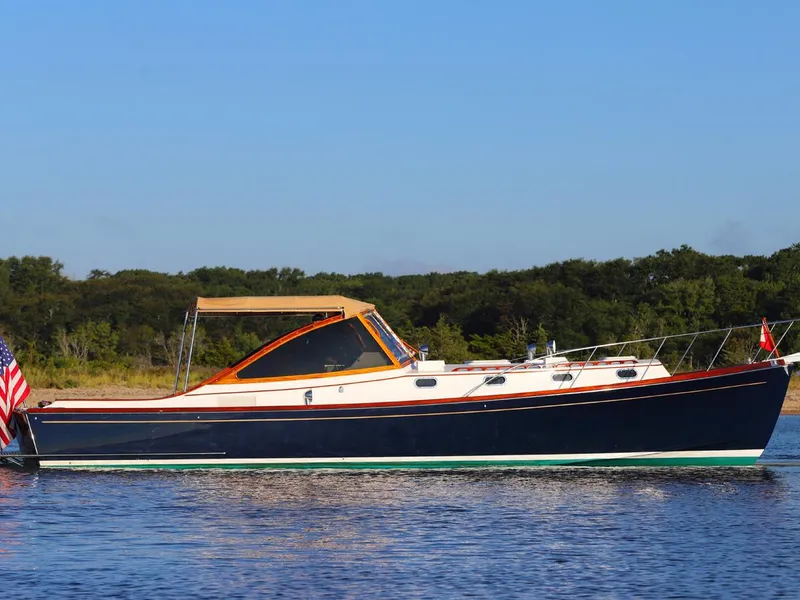 Slide: The Image of Able 44 boat from 1995 on calm water with clear blue sky. - 18