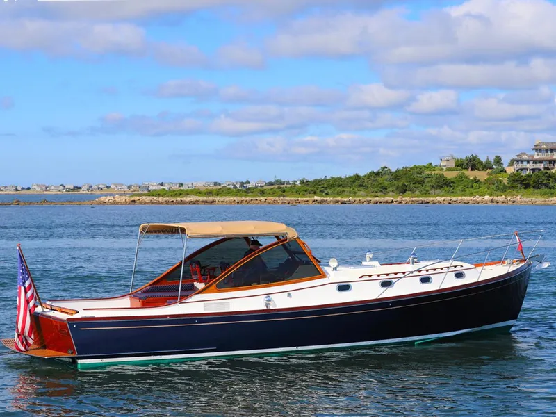 Slide: The Image of Classic 1995 Able 44 yacht cruising on a sunny day with scenic coastal backdrop. - 19