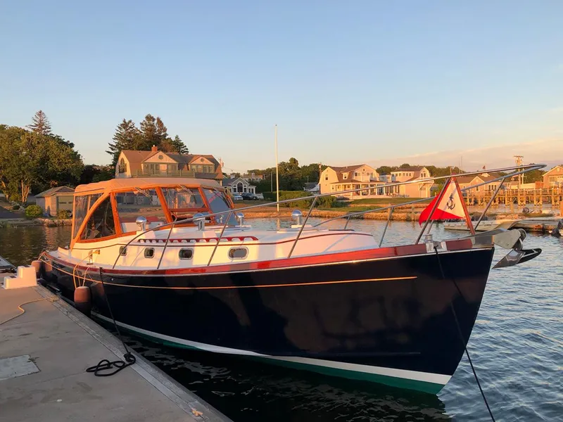 Slide: The Image of Classic 1995 Able 44 yacht docked at a scenic marina during sunset. - 2