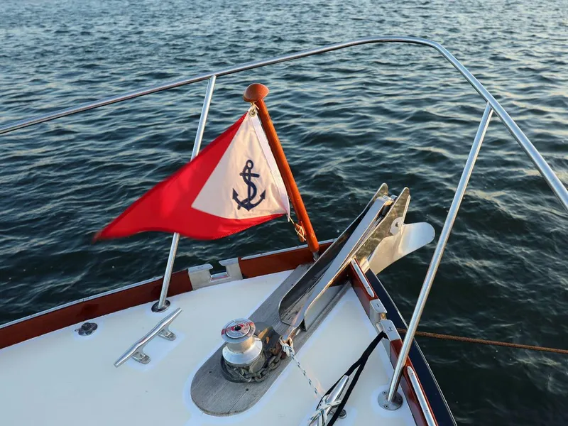 Slide: The Image of Bow of 1995 Able 44 boat with anchor flag on calm water. - 3