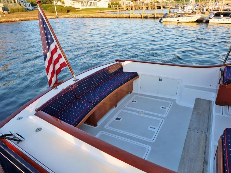 Slide: The Image of 1995 Able 44 boat deck with American flag, docked by calm waters. - 5