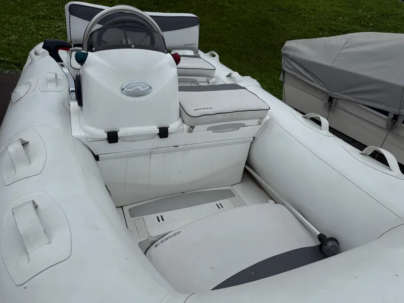 Slide: The Image of 2011 Walker Bay Console Genesis 310FTD inflatable boat with steering console and seating. - 3