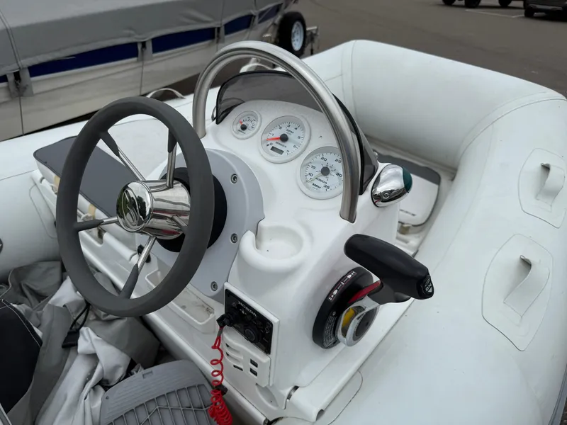 Slide: The Image of 2011 Walker Bay Console Genesis 310FTD boat steering console with gauges and controls. - 5
