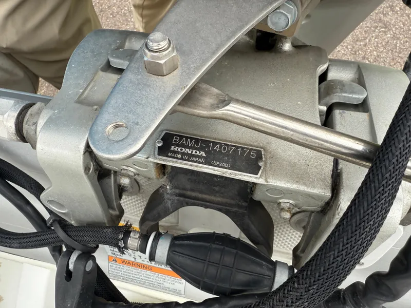 Slide: The Image of Close-up of a Honda engine part on a 2011 Walker Bay Console Genesis 310FTD boat. - 6
