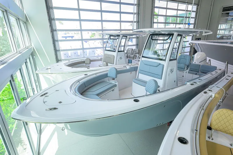 The Image of 2026 Sportsman Heritage 231 Center Console boat in showroom, featuring sleek design and modern amenities. - 0
