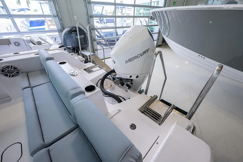 Slide: The Image of 2026 Sportsman Heritage 231 Center Console with Mercury outboard engine in showroom. - 22