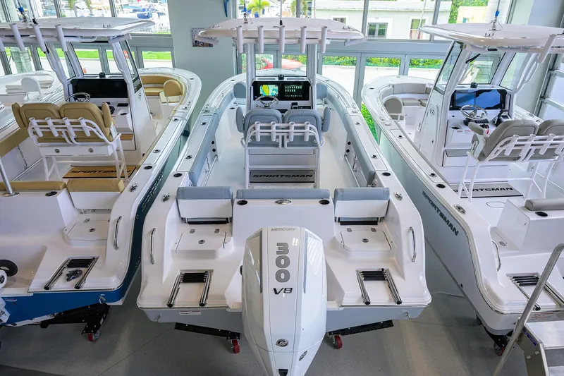 Slide: The Image of 2026 Sportsman Heritage 231 Center Console boats displayed in a showroom. - 27