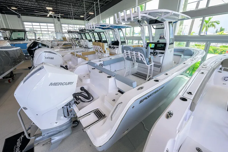 Slide: The Image of 2026 Sportsman Heritage 231 Center Console boat in showroom with Mercury engine. - 29