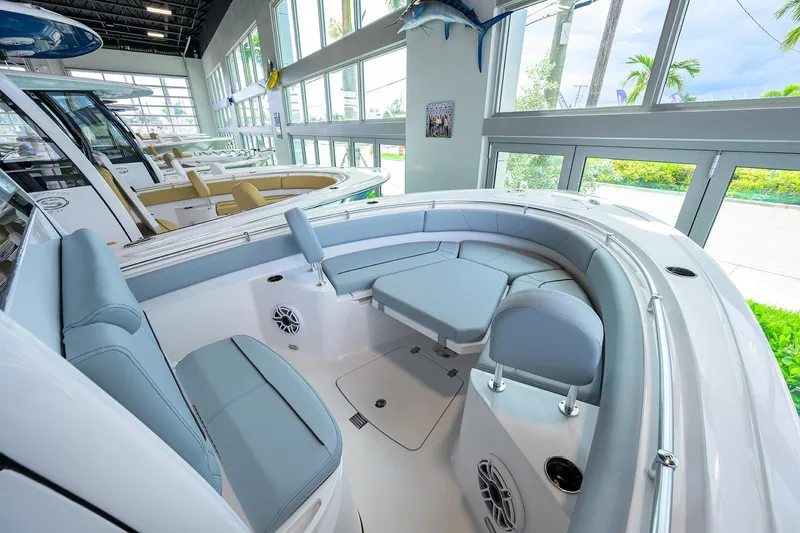 Slide: The Image of 2026 Sportsman Heritage 231 Center Console boat interior with cushioned seating and modern design. - 6