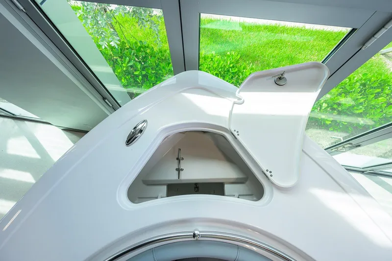 Slide: The Image of 2026 Sportsman Heritage 231 Center Console boat storage compartment open. - 9