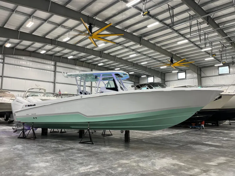 The Image of 2026 Wellcraft 352 Fisherman boat in a spacious indoor showroom. - 1