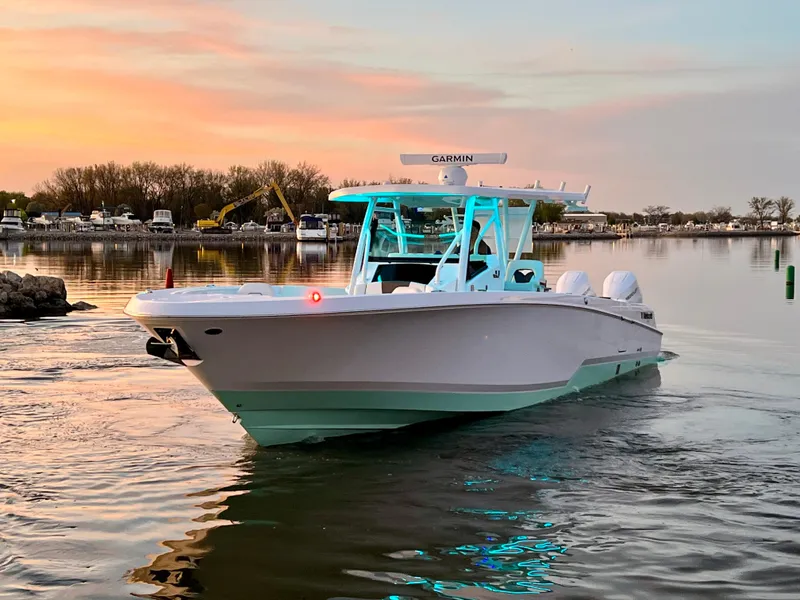 Slide: The Image of 2026 Wellcraft 352 Fisherman boat on calm water at sunset, featuring Garmin equipment. - 10