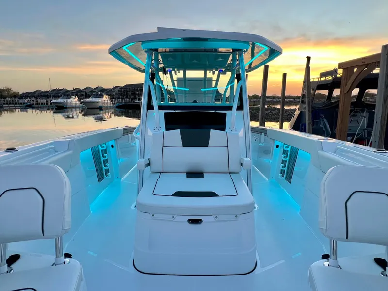 Slide: The Image of 2026 Wellcraft 352 Fisherman boat with illuminated deck at sunset in marina. - 13