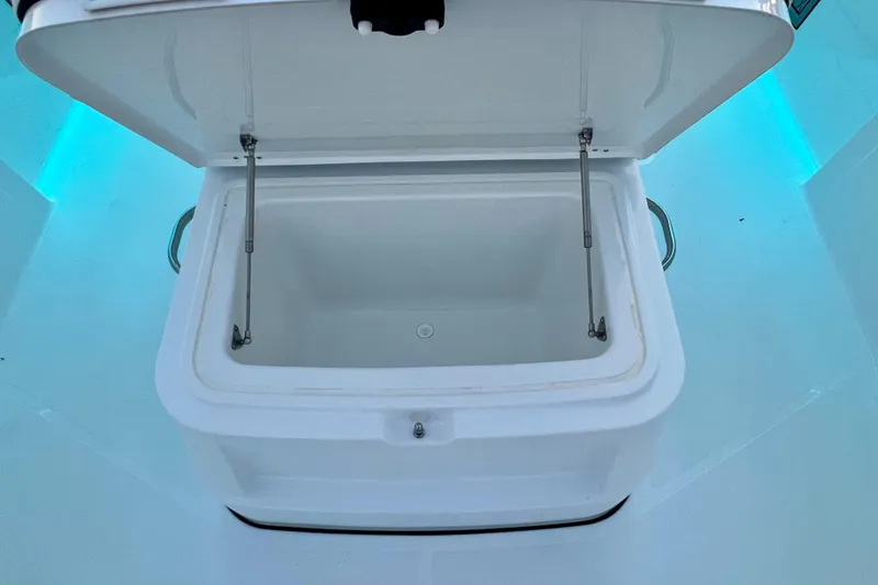 Slide: The Image of Open storage compartment on 2026 Wellcraft 352 Fisherman boat, illuminated with blue lighting. - 15