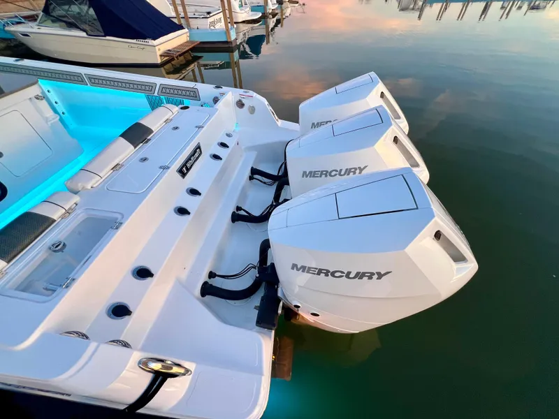 Slide: The Image of 2026 Wellcraft 352 Fisherman boat with triple Mercury engines docked at sunset. - 26