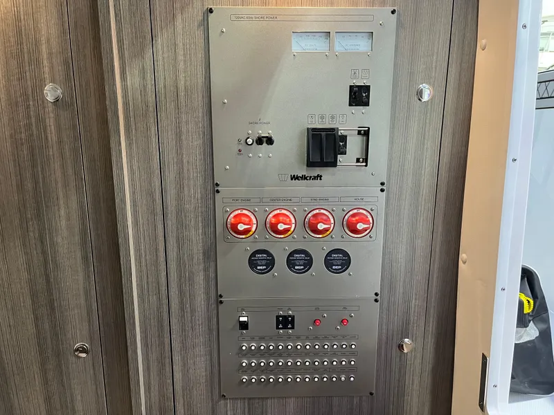Slide: The Image of Electrical control panel of 2026 Wellcraft 352 Fisherman boat, featuring switches and gauges. - 29