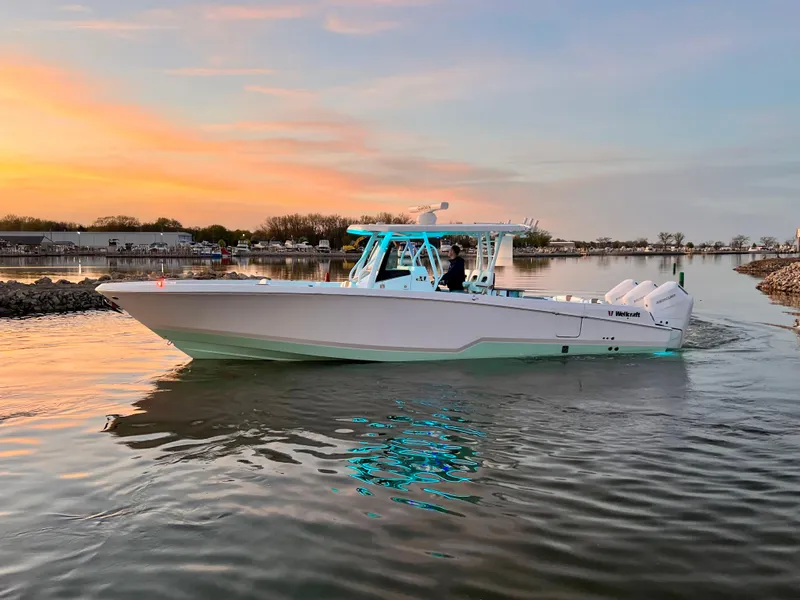 Slide: The Image of 2026 Wellcraft 352 Fisherman boat cruising at sunset on calm waters. - 3
