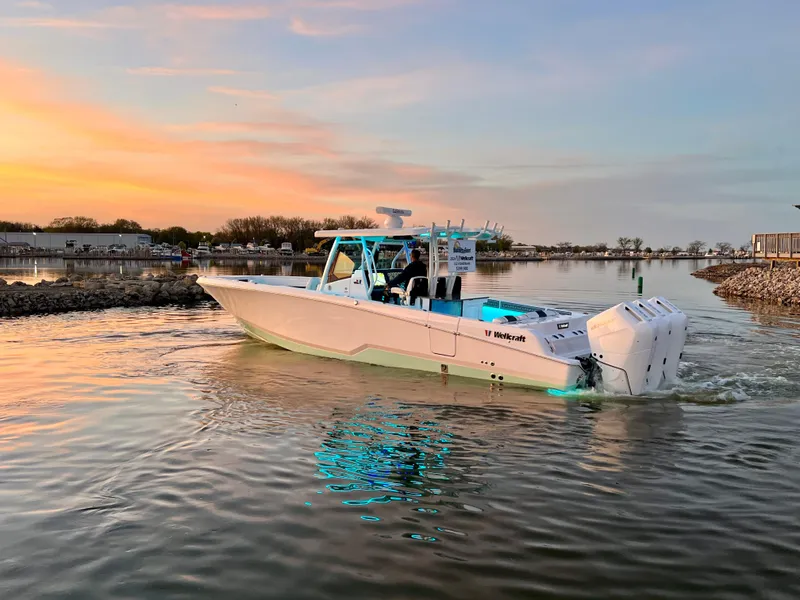 Slide: The Image of 2026 Wellcraft 352 Fisherman boat cruising at sunset on calm waters. - 4