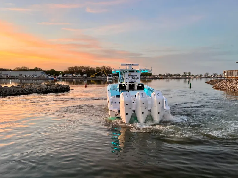 Slide: The Image of 2026 Wellcraft 352 Fisherman boat cruising at sunset on a calm waterway. - 5