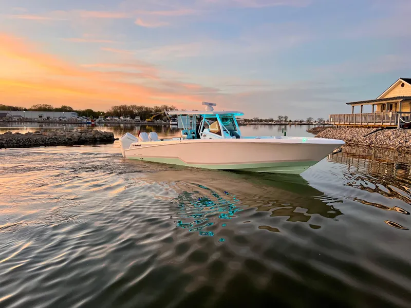 Slide: The Image of 2026 Wellcraft 352 Fisherman boat on calm water at sunset, near a dock. - 8