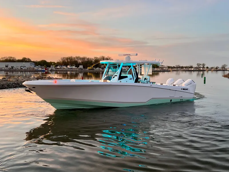 Slide: The Image of 2026 Wellcraft 352 Fisherman boat on calm water at sunset. - 9