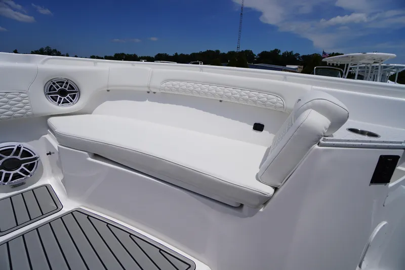 Slide: The Image of 2026 Tidewater 282 CC Adventure boat interior with white seating and speakers. - 12