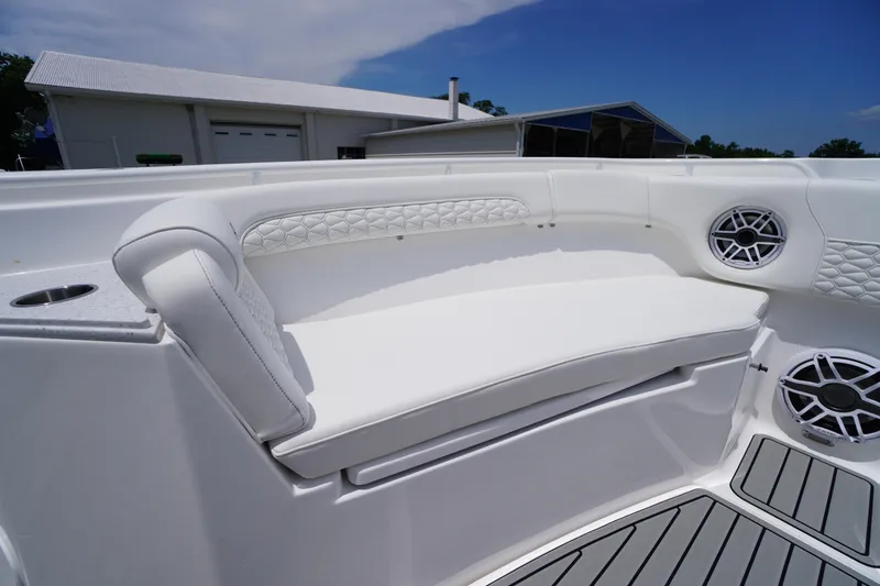 Slide: The Image of 2026 Tidewater 282 CC Adventure boat interior with white cushioned seating and speakers. - 13