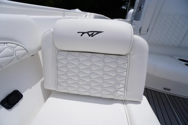 Slide: The Image of White leather seat on 2026 Tidewater 282 CC Adventure boat, featuring hexagonal stitching. - 14