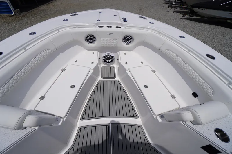 Slide: The Image of 2026 Tidewater 282 CC Adventure boat interior with cushioned seating and storage compartments. - 15